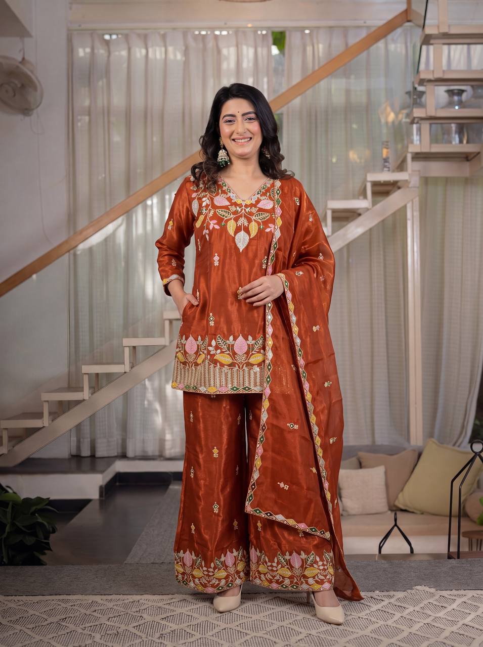 Elegant Rust Orange Silk Kurta and Flared Palazzo Set Adorned with Intricate Multicolored Botanical Embroidery and Mirror Work